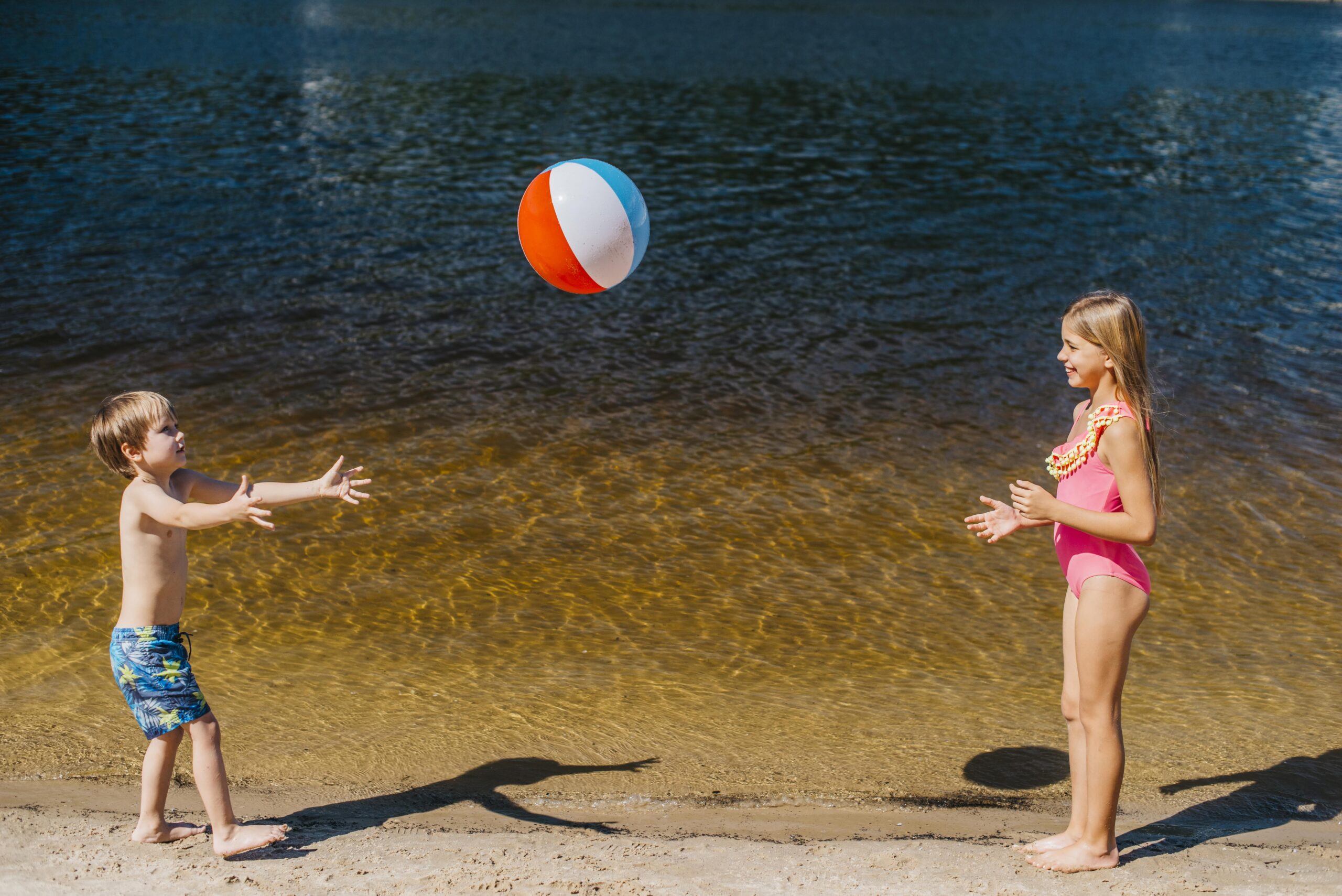 Kids Playing Near Water with Ball