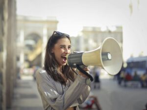 Women shouting on megaphone